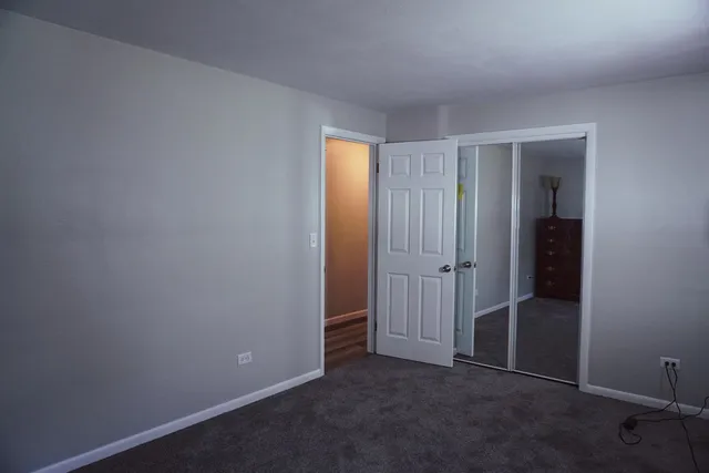 an empty room with closet area