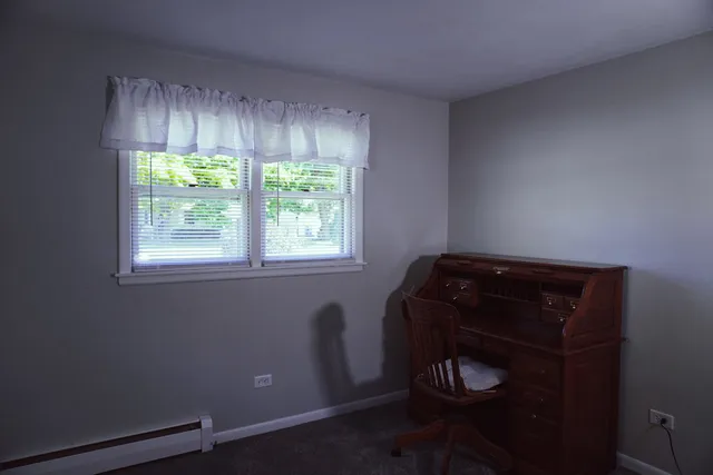 a room with a window and a chair