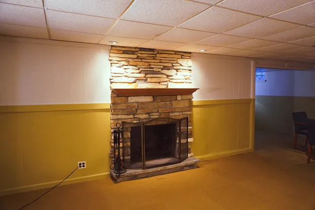 a view of a livingroom with fireplace and a window