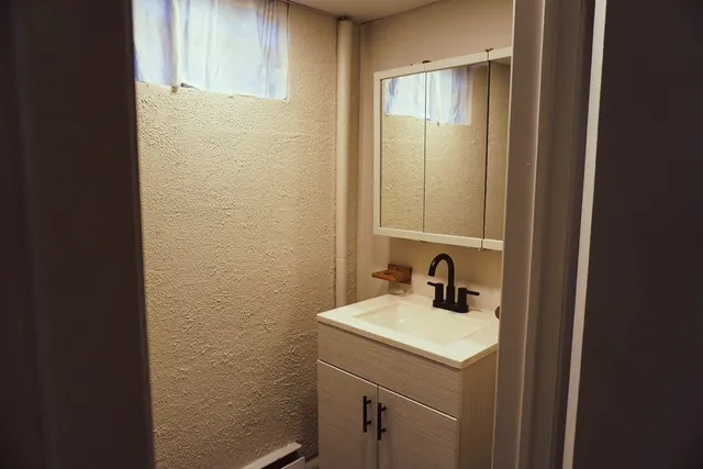 a bathroom with a sink and a mirror