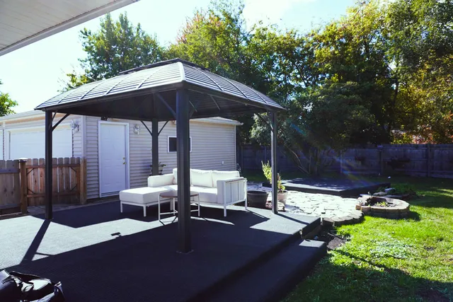 a view of backyard with outdoor seating and plants