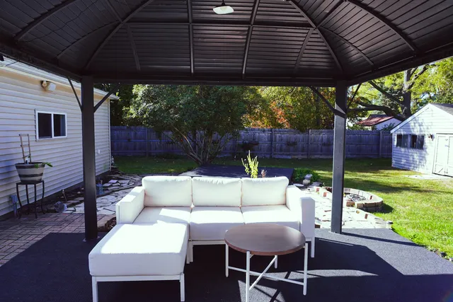 a view of a patio with a table chairs and a yard