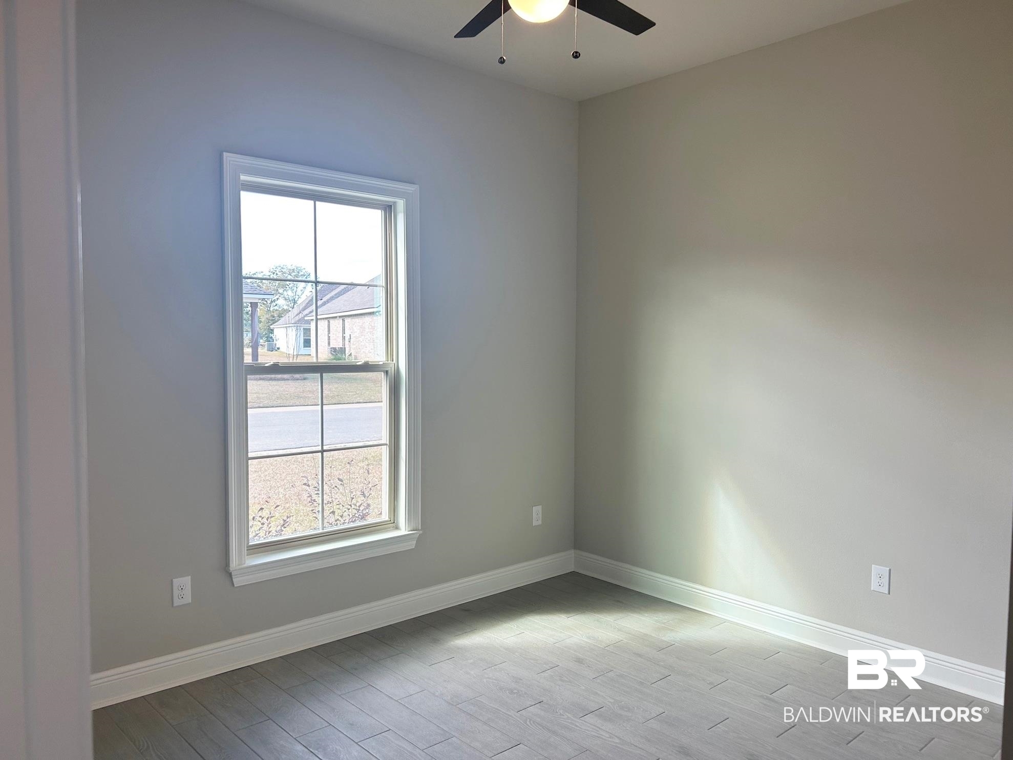 881 Sumter Loop Foley, AL 36535 - Photo 13 of 19 Empty room with plenty of natural light, light hardwood / wood-style floors, and ceiling fan