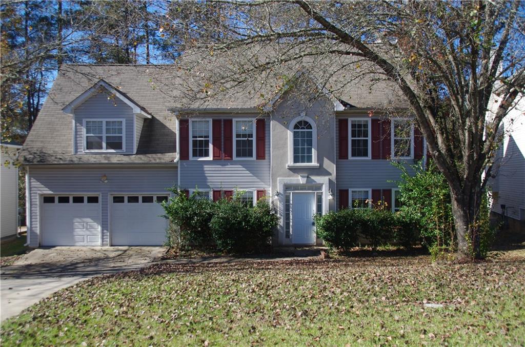 5686 Spring Mill Circle Lithonia, GA 30038 - Photo 1 of 1 a front view of a house with a yard