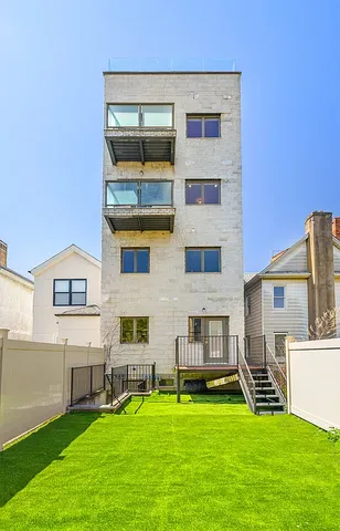 a view of an apartment with a backyard