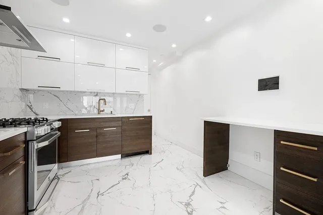a kitchen with stainless steel appliances granite countertop a stove and a refrigerator