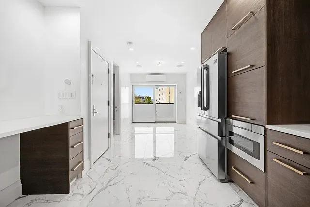 a kitchen with stainless steel appliances a refrigerator and cabinets