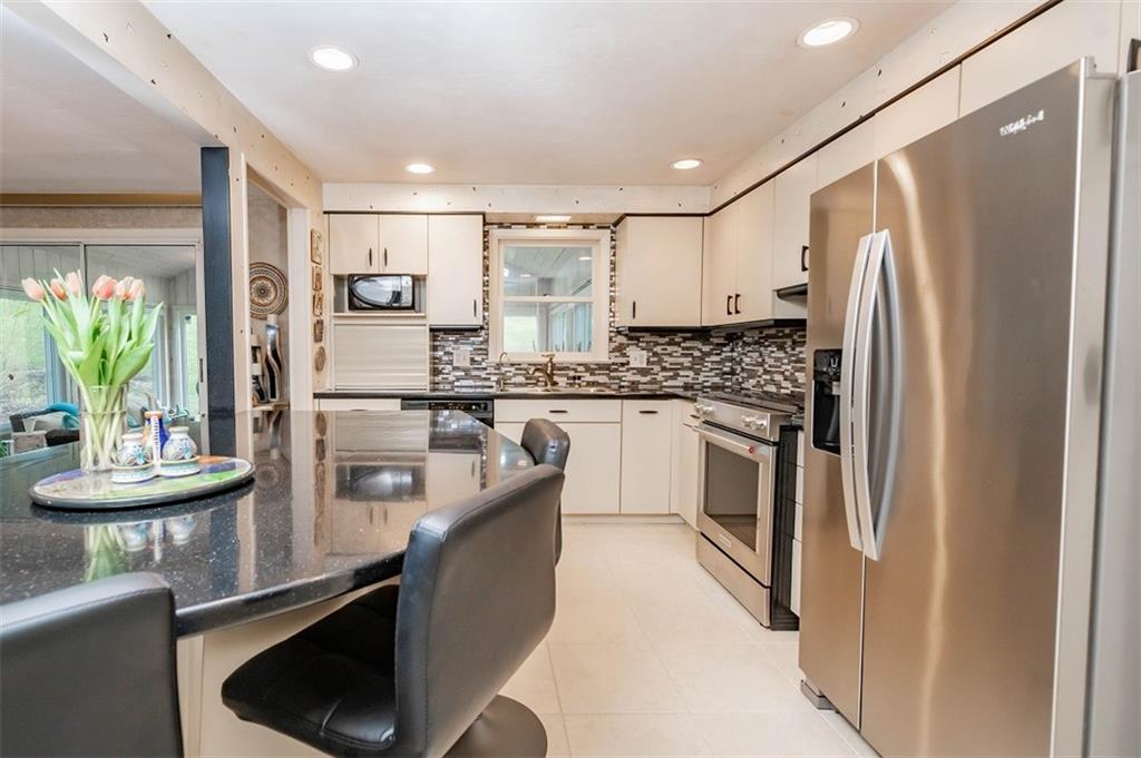 2740 Rebecca Street Indiana, PA 15701 - Photo 8 of 25 a kitchen with stainless steel appliances granite countertop a refrigerator a stove and a sink