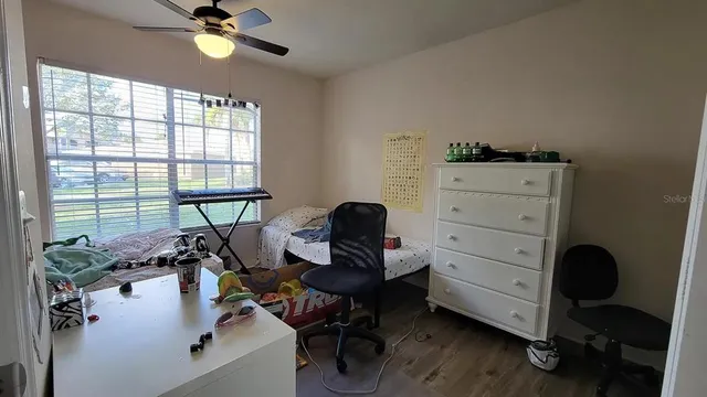 a view of a workspace with furniture and a window
