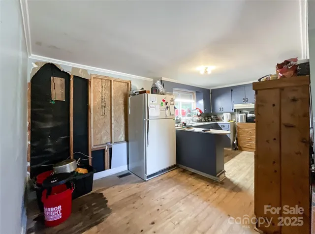 a kitchen with refrigerator and window