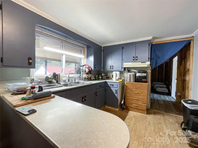 a kitchen with granite countertop a sink appliances and cabinets