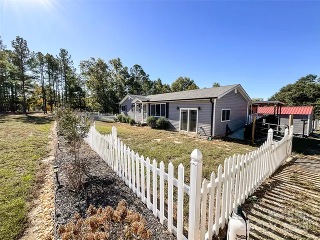 a view of a house with wooden fence