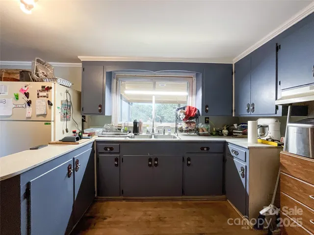 a kitchen with stainless steel appliances granite countertop a sink and cabinets