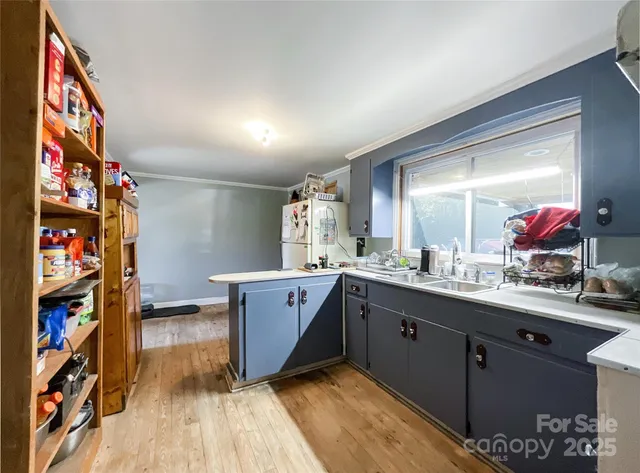 a view of a hallway with wooden floor and windows