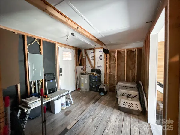 a view of a living room with wooden floor and furniture