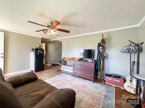 a bedroom with furniture and a flat screen tv