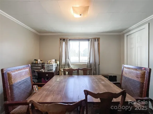a dining room with furniture and window