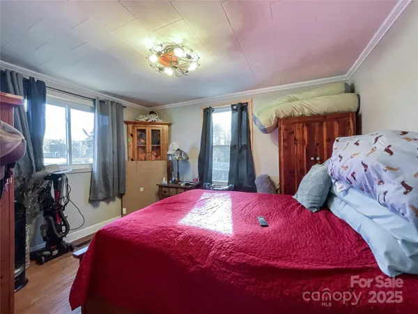 a bedroom with a bed and a dresser with mirror