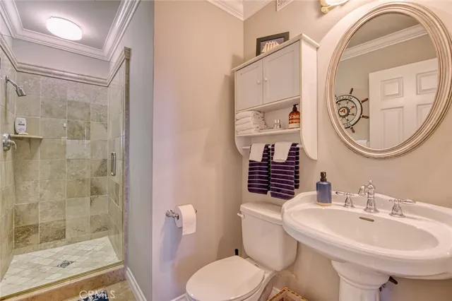 a bathroom with a granite countertop toilet a sink and mirror