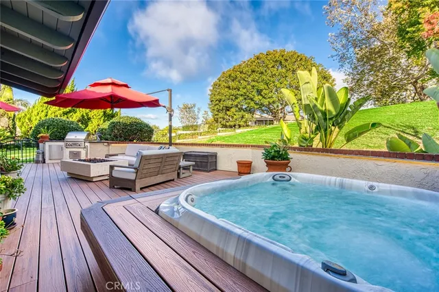 a view of a patio with couches and table under an umbrella