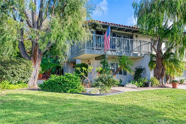 a bedroom with furniture and a large window