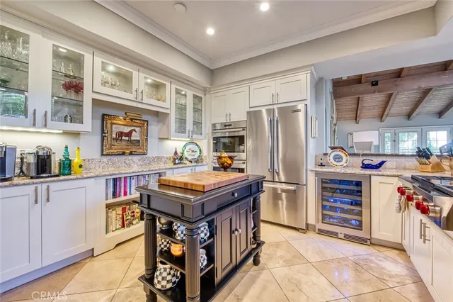 a view of a dining room with furniture a chandelier and wooden floor