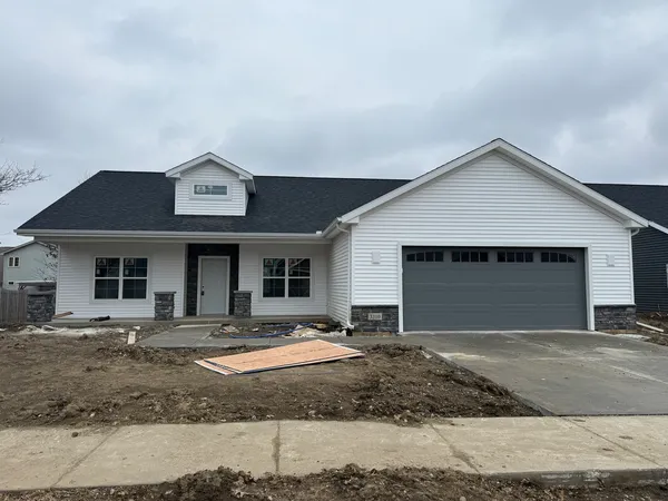 a front view of a house with yard and garage