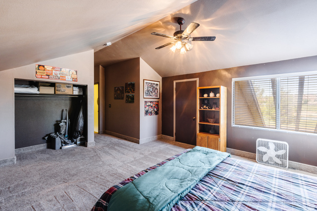 1470 Redwood Tree Street St. George, UT 84790 - Photo 30 of 53 Carpeted room featuring a sloped ceiling, ceiling fan with integrated lighting, a double window with horizontal blinds, and a built-in closet space