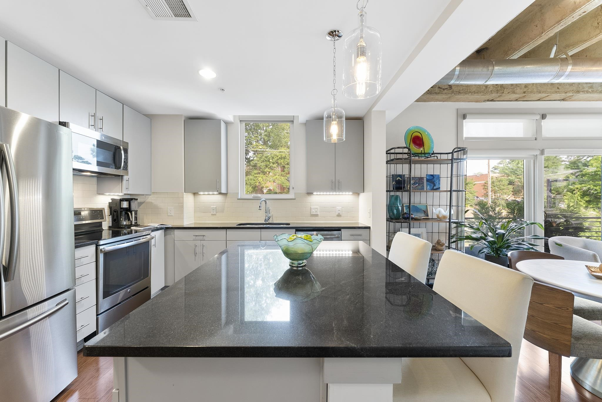 1300 St Marys Street, Unit 306 Raleigh, NC 27605 - Photo 14 of 30 a kitchen with a table chairs and a refrigerator