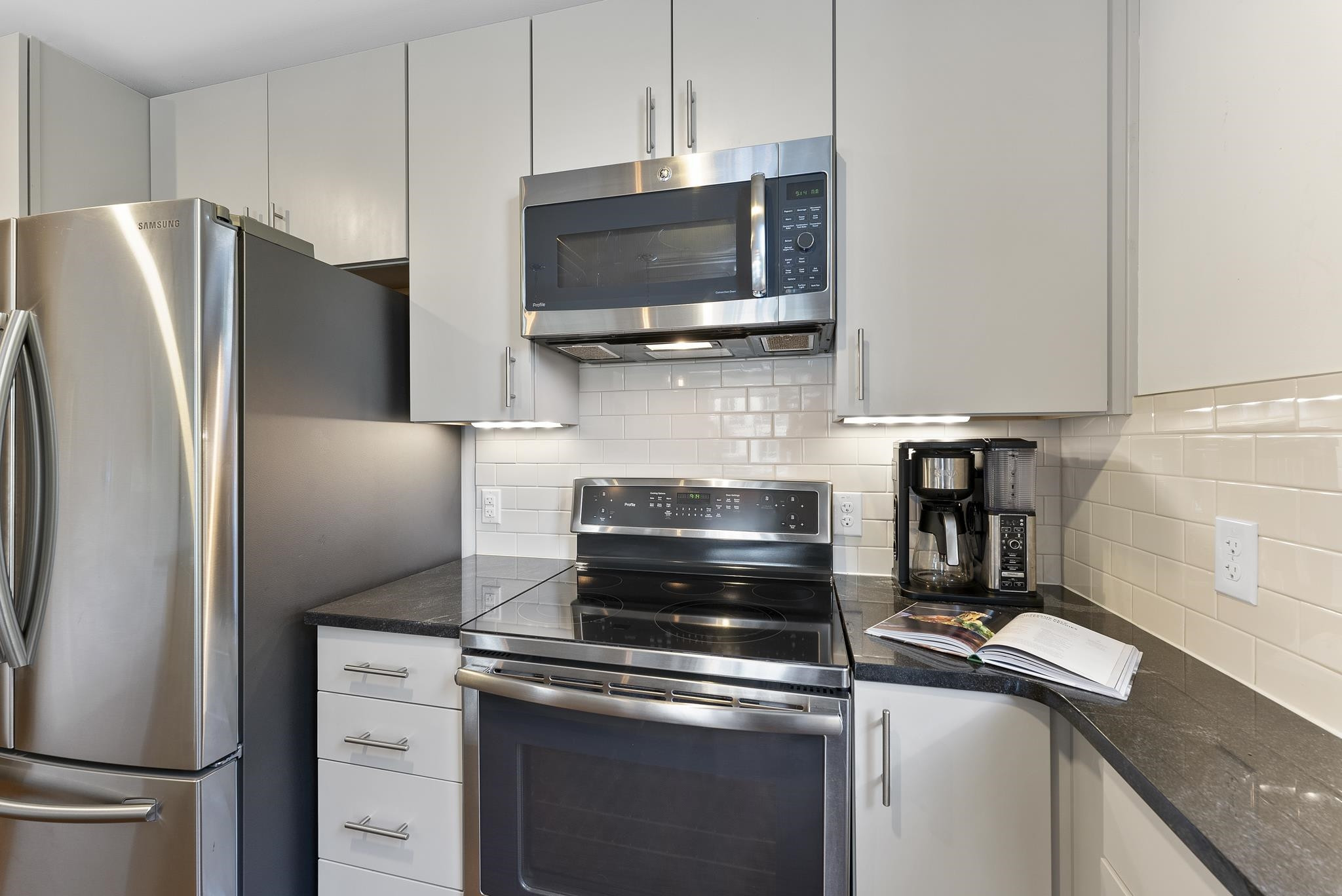 1300 St Marys Street, Unit 306 Raleigh, NC 27605 - Photo 15 of 30 a kitchen with a refrigerator stove and microwave