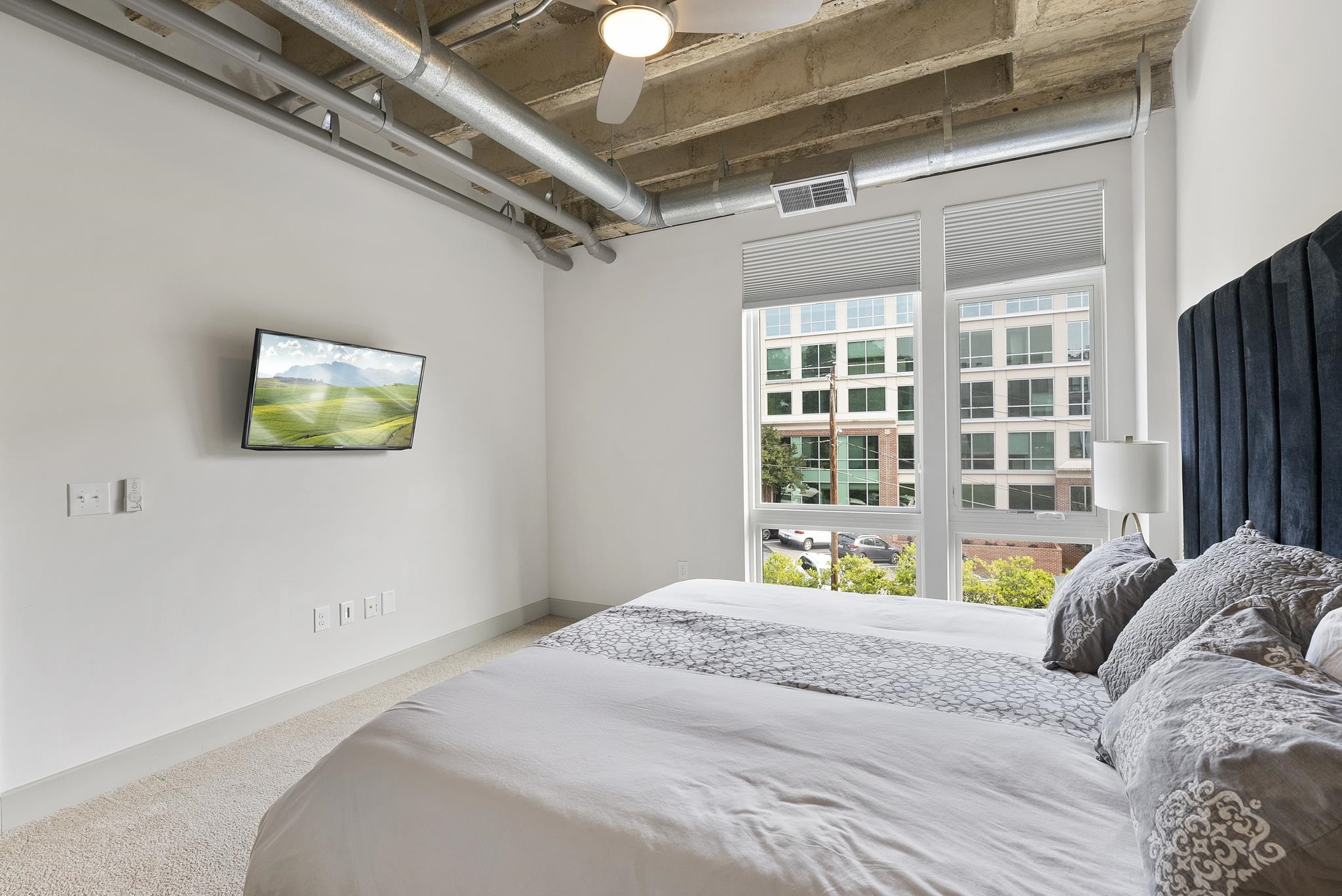 1300 St Marys Street, Unit 306 Raleigh, NC 27605 - Photo 17 of 30 a bedroom with a bed and a window