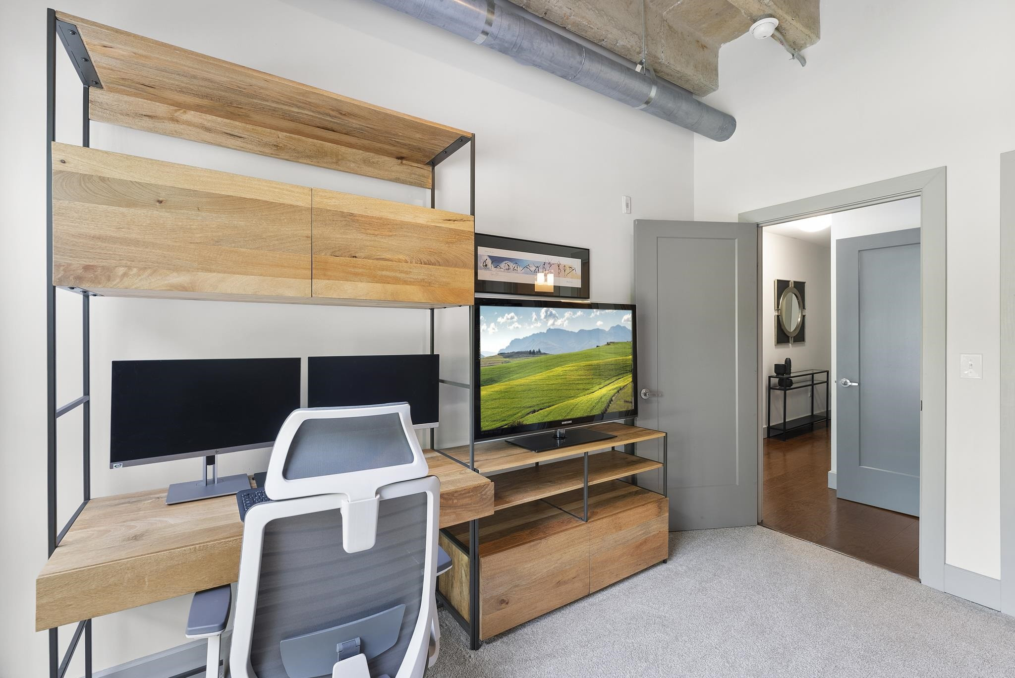 1300 St Marys Street, Unit 306 Raleigh, NC 27605 - Photo 22 of 30 a living room with furniture flat screen tv and a fireplace