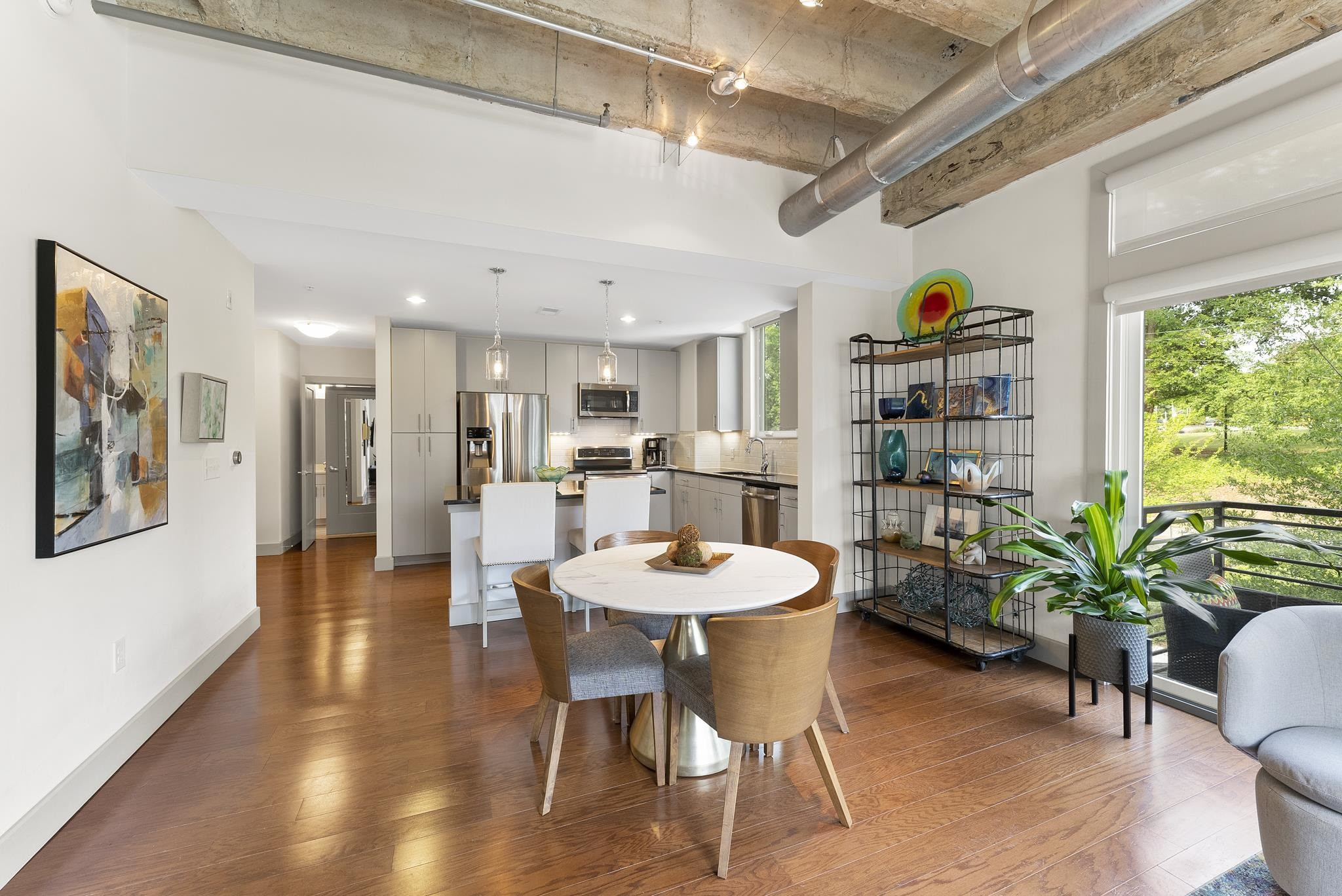 1300 St Marys Street, Unit 306 Raleigh, NC 27605 - Photo 3 of 30 a dining room with furniture and a floor to ceiling window