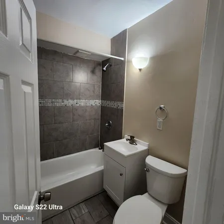 a bathroom with a toilet a sink and bathtub