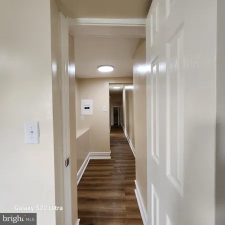 a view of a hallway with wooden floor