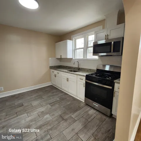 a kitchen with stainless steel appliances granite countertop a stove and a sink