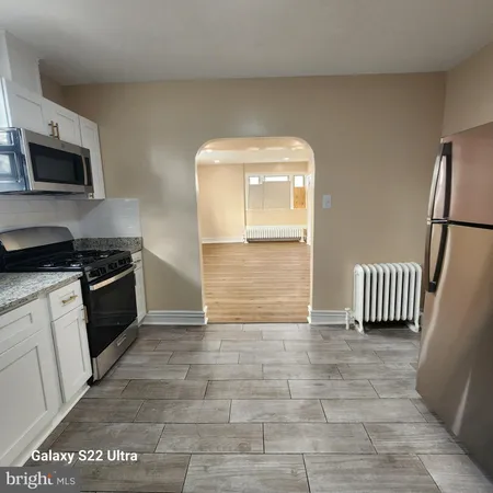 a kitchen with granite countertop a stove and a refrigerator
