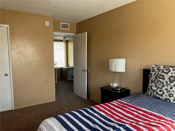 a bedroom with bed and wooden floor