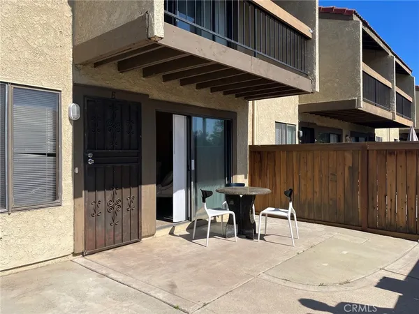 a view of a patio with table and chairs