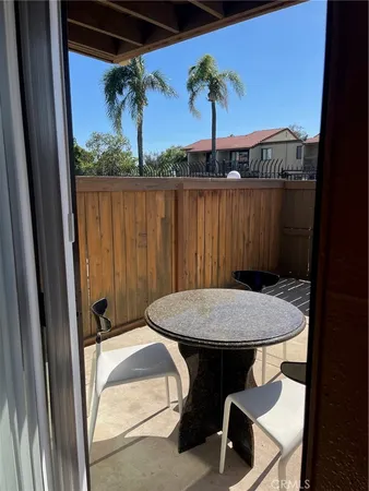 a view of a balcony with table and chairs