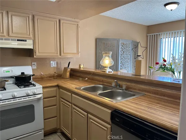 a kitchen with a sink stove and cabinets