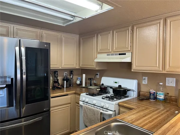 a kitchen with a refrigerator and cabinets