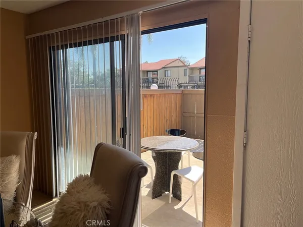 a view of a hallway with furniture and a window