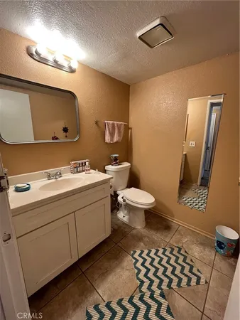 a bathroom with a sink a toilet and mirror