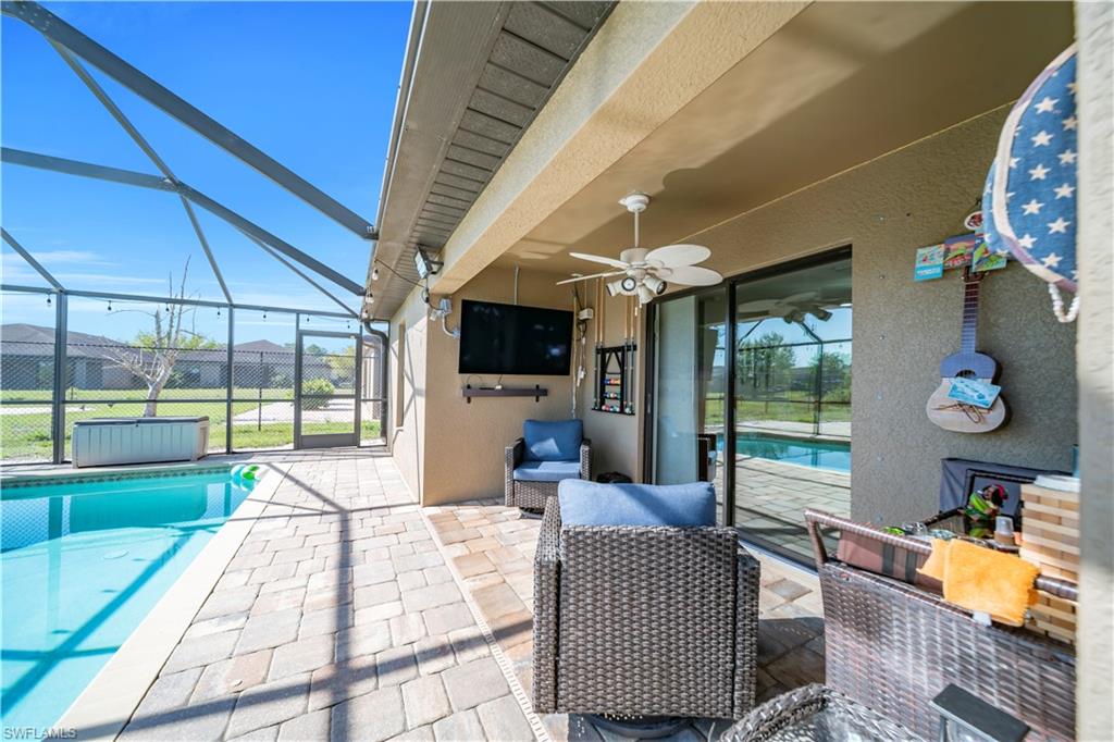 175 Shadowview Court Lehigh Acres, FL 33974 - Photo 7 of 39 a living room with furniture and a floor to ceiling window