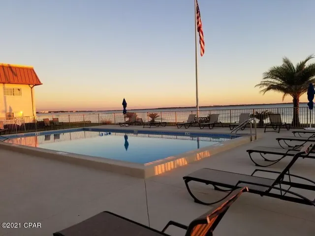 a view of a swimming pool with outdoor seating