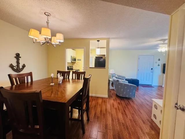 a view of a dining room with furniture wooden floor and chandelier