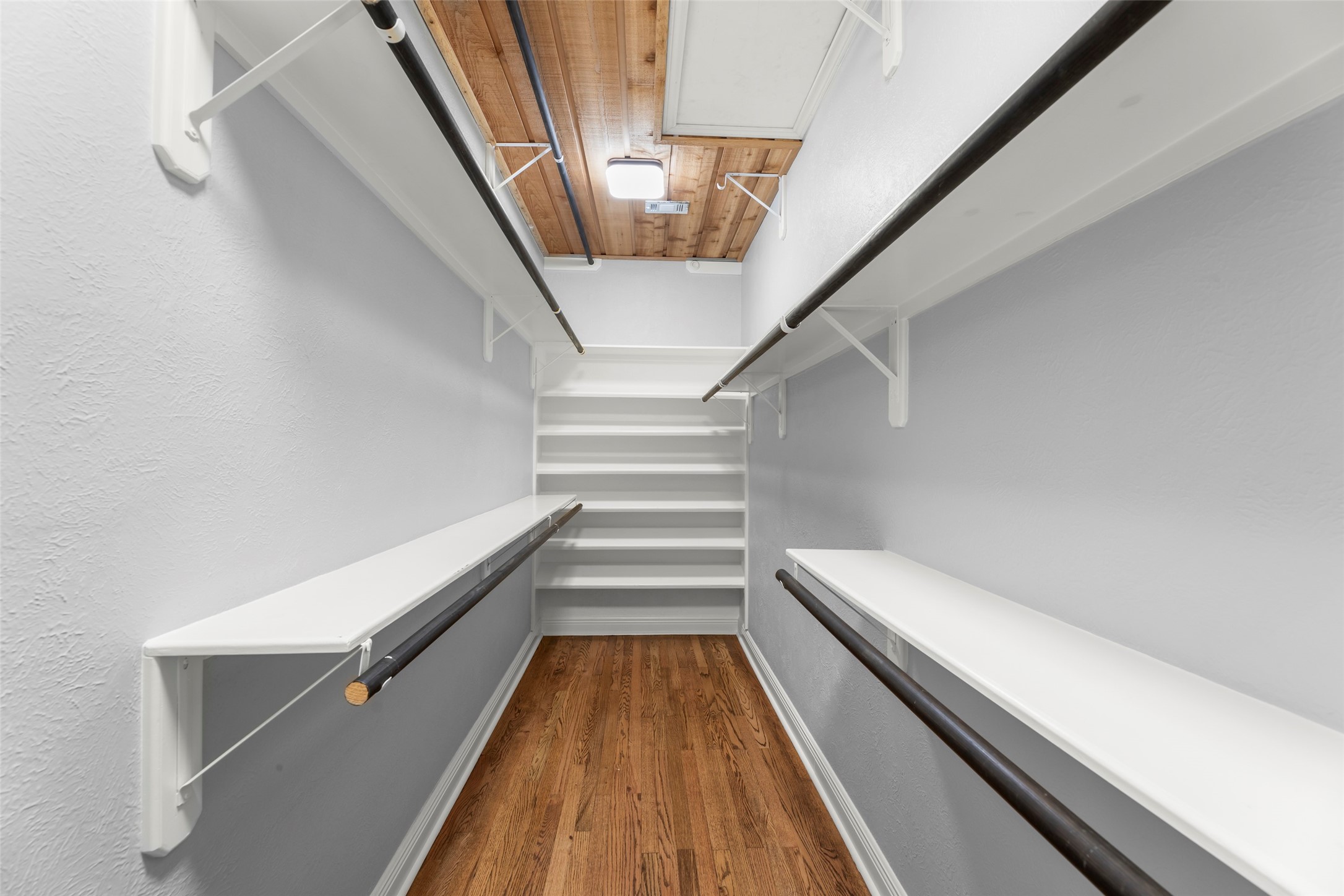 1120 Winston Street Houston, TX 77009 - Photo 24 of 35 The primary suite offers a custom-designed Topped with a striking cedar ceiling, the space leverages natural humidity control to preserve and protect your wardrobe,closet.