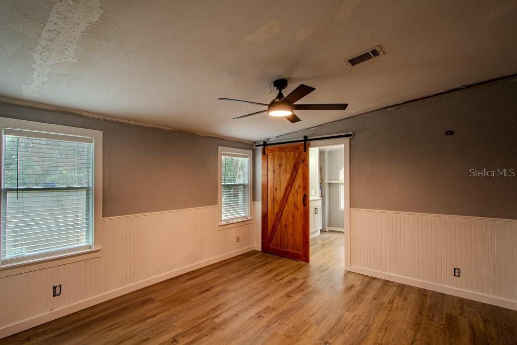 448 Southwest Central Terrace Fort White, FL 32038 - Photo 13 of 19 a view of an empty room with a window and wooden floor
