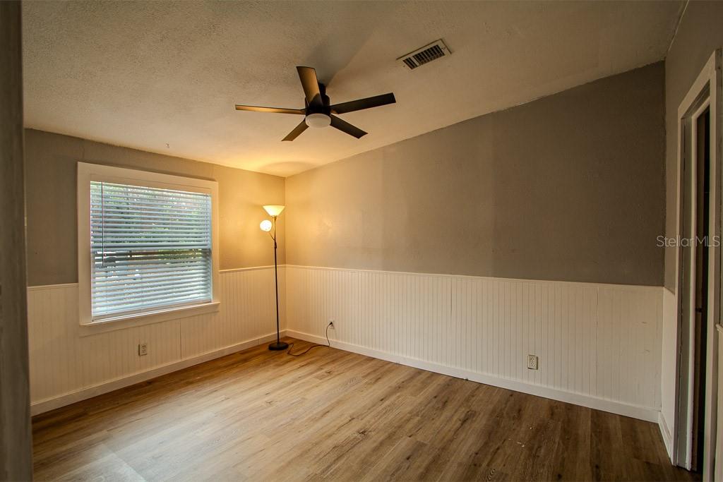 448 Southwest Central Terrace Fort White, FL 32038 - Photo 14 of 19 a view of empty room with wooden floor and fan